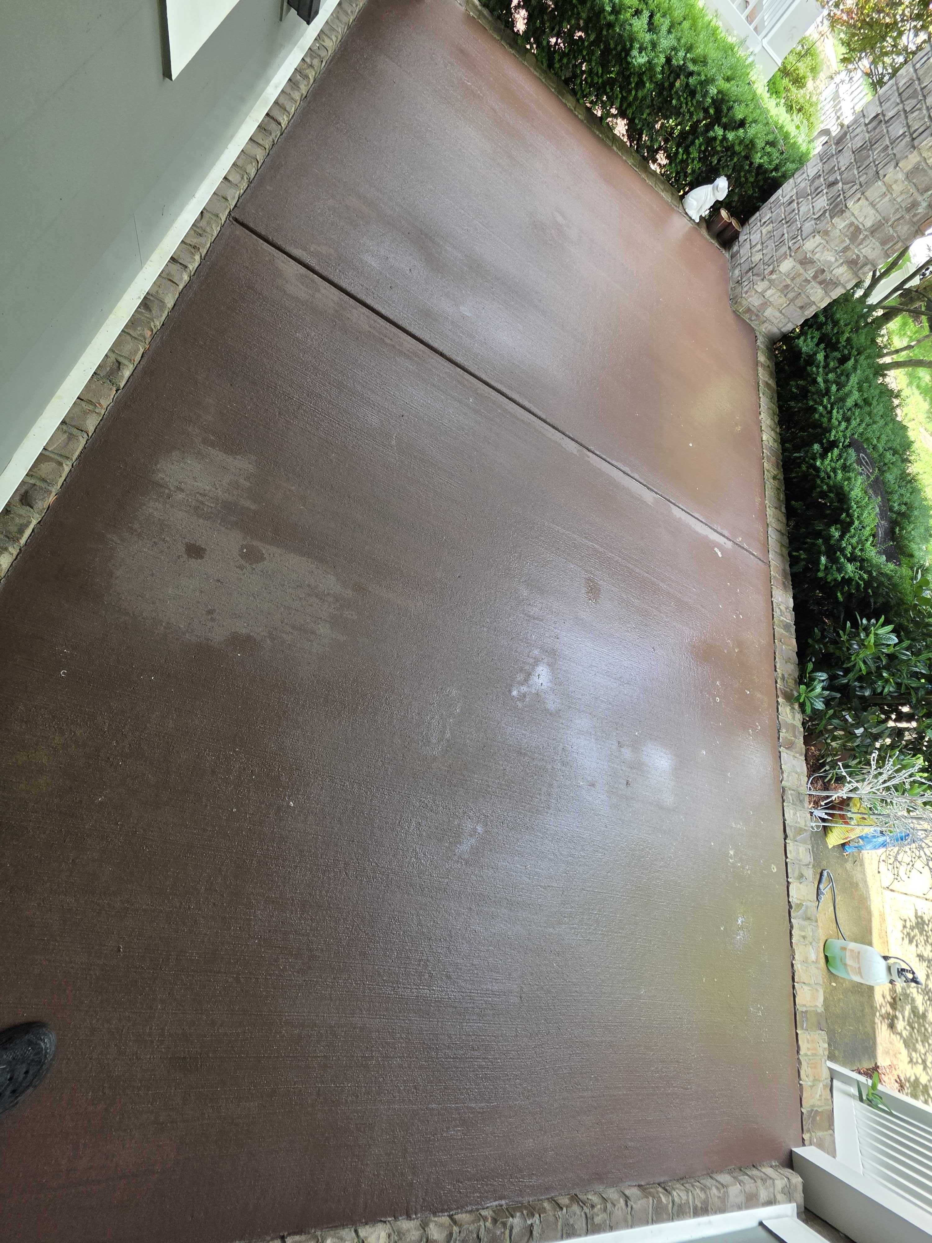 stained brown concrete porch slab with brick edging