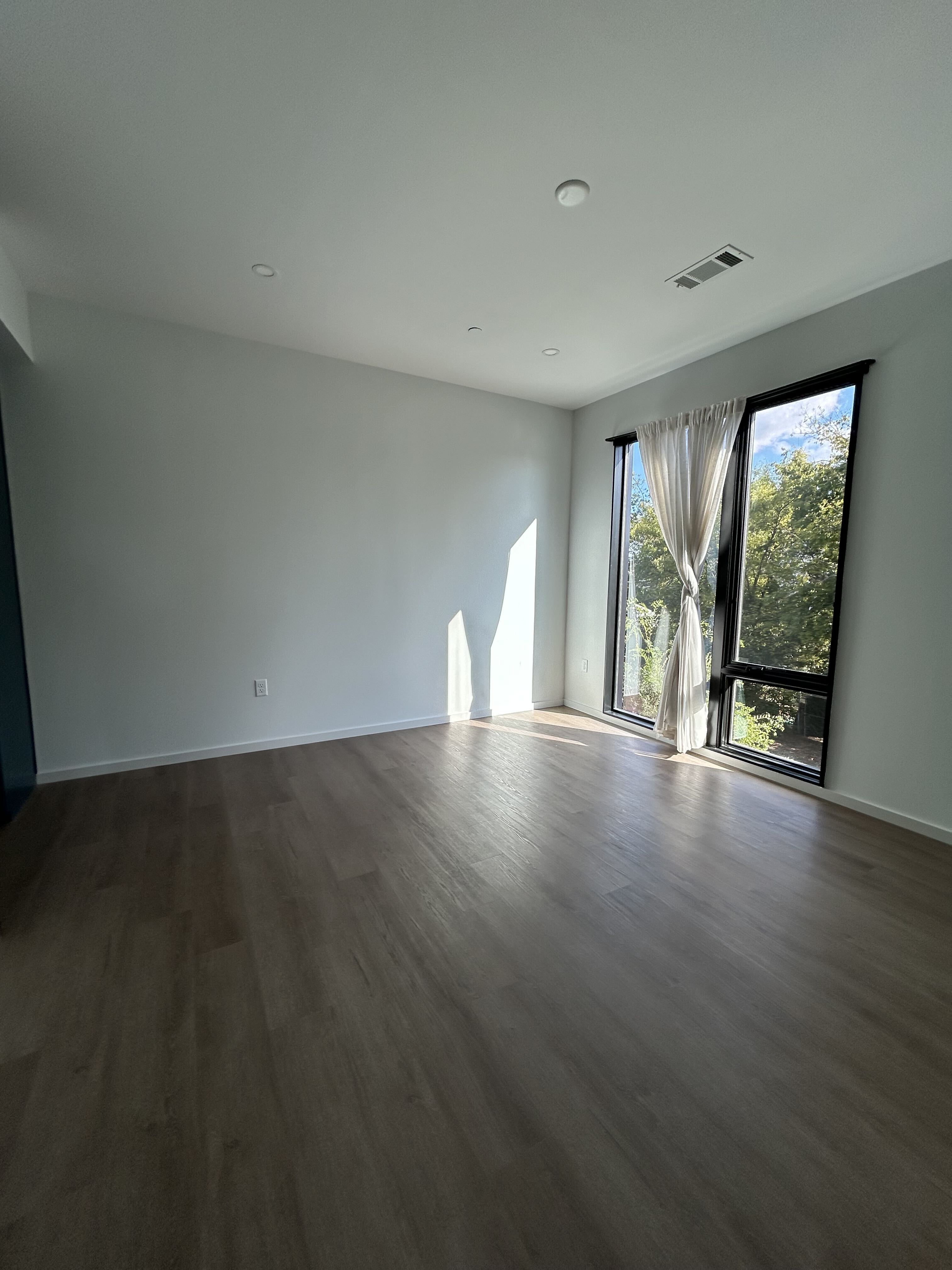 Freshly painted bedroom with bright white walls and ceiling in a Nashville condo
