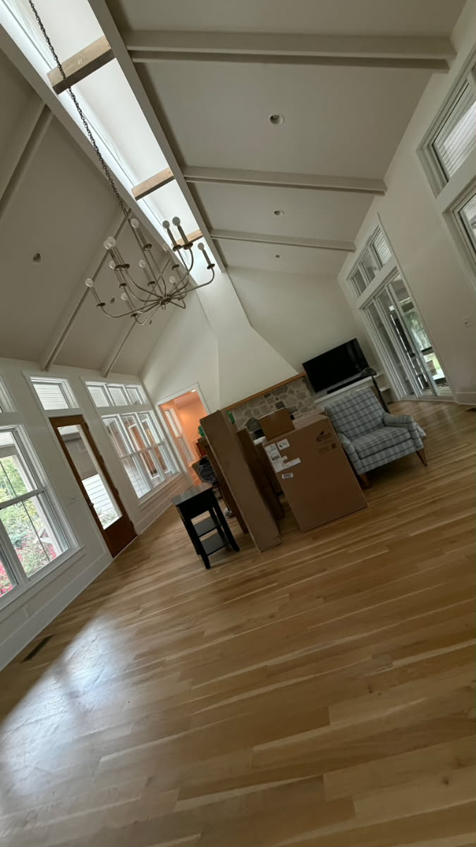 Bright open-concept great room with painted coffered ceiling and fresh white trim